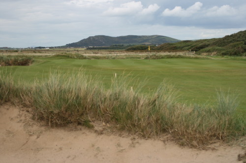 A bunker guards the green on the eighth hole at Aberdovey Golf Club.
