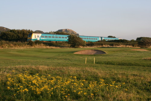 A train runs in the background of the No. 4 hole at North Wales Golf Club in Llandudno, Wales.