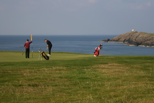 Brothers Deio Williams (left) and Cian Williams putt on the third green at Nefyn & District Golf Course in North Wales.