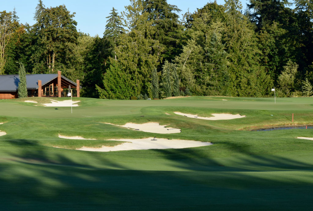 The clubhouse at Salish Cliffs Golf Club sits behind a double-green for the No. 18 and No. 9 holes.