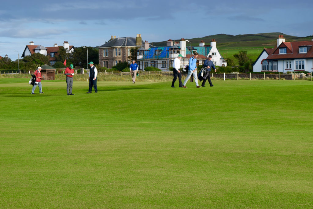 Golfers and caddies finish a round at Machrihanish Golf Club.