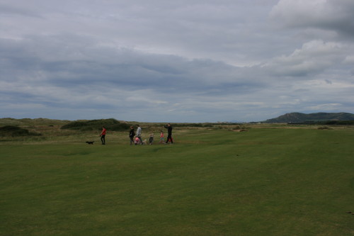 A family crosses the sixth fairway en route to the beach at Aberdovey Golf Club in Wales.