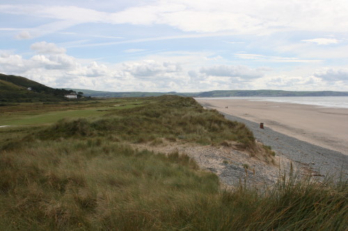 Dunes separate the sea and beach from Aberdovey Golf Club in Wales.