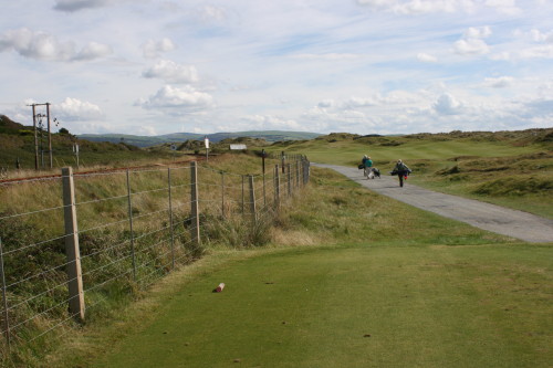 Train tracks run alongside Aberdovey Golf Club in Wales, with a depot near the first tee.