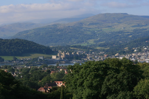 Conwy Castle and the mountains of Snowdonia, as viewed from the top tower at Bodysgallen Hall, Llandudno, Wales.