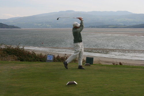 In a stiff wind, Tom Cade tees off on the par 4 No. 12 hole at Porthmadog Golf Club in North Wales.