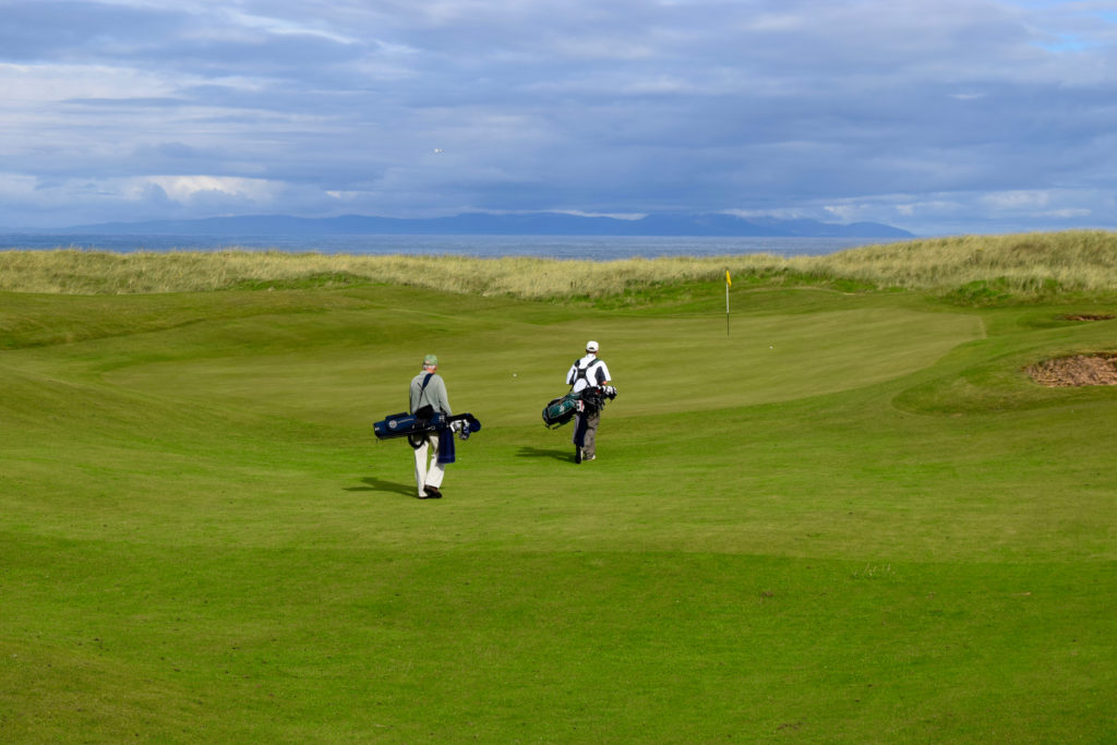 Tom Cade and Rob Perry at the No. 3 green at Machrihanish Golf Club, with the island of Isla in the distance.