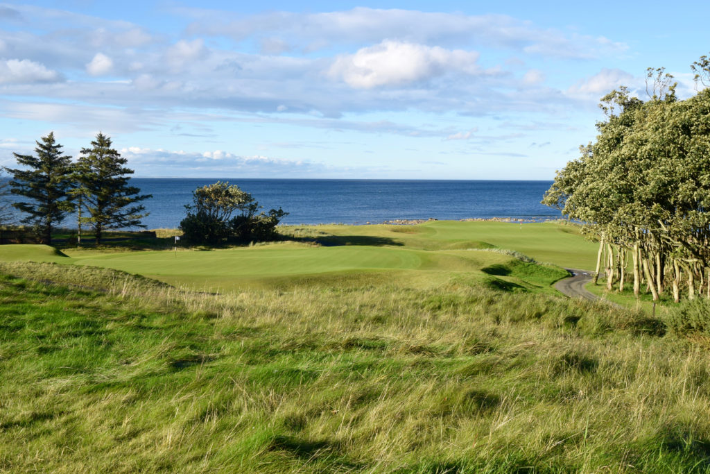 From behind the 11th hole, a view of the No. 8 and No. 15 greens at Kingsbarns Golf Club, reflecting the tiered layout of the course.