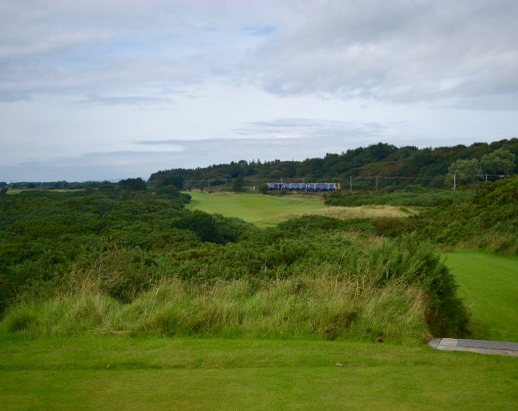A train races by on the The Railway hole, No. 11 at Royal Troon Golf Club in Troon, Scotland.